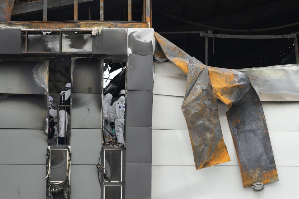 Members of the National Forensic Service Investigate the site of a burnt battery manufacturing factory in Hwaseong, South Korea, Tuesday, June 25, 2024. (AP Photo/Lee Jin-man)