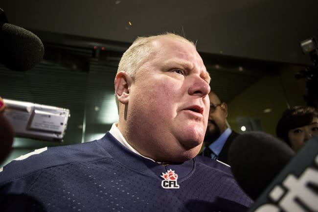 Toronto Mayor Rob Ford scrums with the media as he arrives at his office on Thursday November 14, 2013. THE CANADIAN PRESS/Chris Young