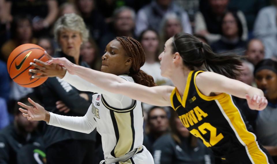 Purdue Boilermakers guard Rashunda Jones (2) and Iowa Hawkeyes guard Caitlin Clark (22) go for a loose ball during of the NCAA women’s basketball game, Wednesday, Jan. 10, 2024, at Mackey Arena in West Lafayette, Ind.