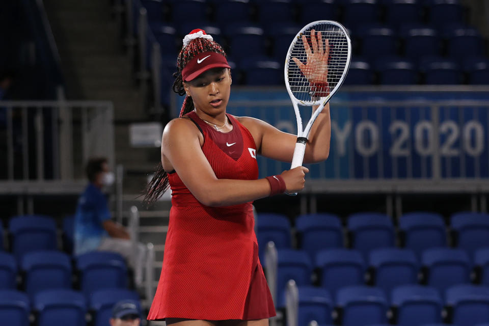 Seen here, Naomi Osaka prepares to leave court after exiting in the third round in Tokyo. 