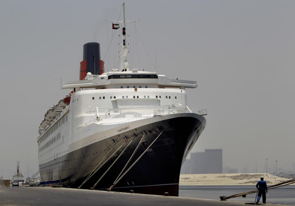 FILE - In this Monday, July 2, 2012 file photo, the Queen Elizabeth 2 is seen at dock as Istithmar World, the Dubai state investment company that owns the ship, outlined plans Monday to turn the retired cruise liner into a 300-room hotel, ending years of speculation about its fate, in Port Rashid, Dubai, United Arab Emirates. The Dubai owners of the storied passenger liner Queen Elizabeth 2 say the ship will be moved to Asia as a floating luxury hotel. (AP Photo/Kamran Jebreili, File)