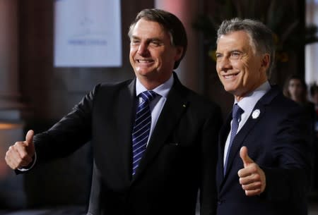 Argentina's President Mauricio Macri and his Brazilian counterpart Jair Bolsonaro pose at the 54th Summit of Heads of State of Mercosur and Associated States, in Santa Fe