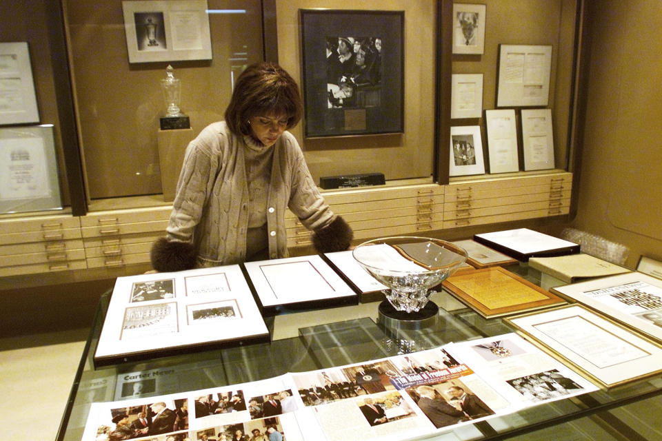 FILE - In this Dec. 10, 2001 file photo Linda Johnson Rice, president and chief operating officer of Jet magazine, looks over awards and recognitions won by the magazine in its 50-year lifetime at Jet's Chicago headquarters. The sale of the photo archive of Ebony and Jet magazines chronicling African American history is generating relief among some who worried the historic images may be lost. But it's also causing some to mourn the fact that the prints won't fully be in the hands of an African American-owned entity. (AP Photo/Ted S. Warren, File)
