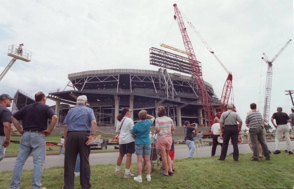 Spectators stand along Park Avenue to witness the 1000-ton Manitowoc 21000 crane lifting the skeletal structure of the new Nittany Lion scoreboard for placement at the north end zone of Beaver Stadium on Aug. 8, 2000.