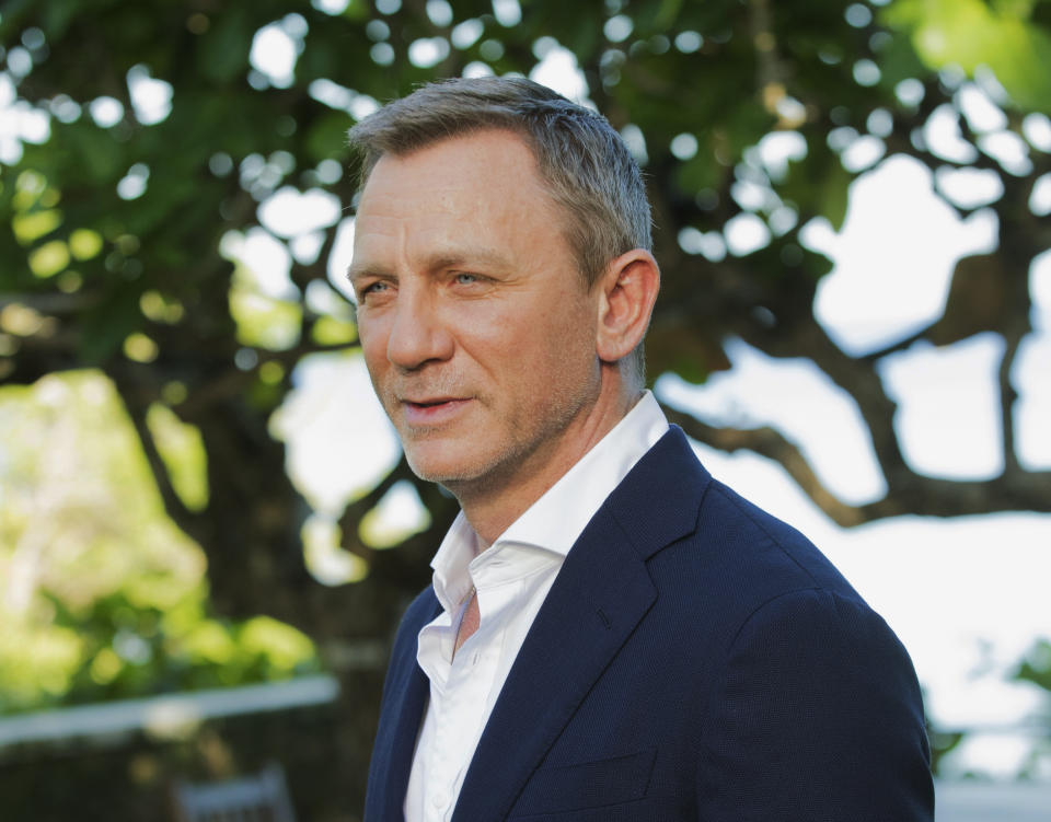 FILE - In this April 25, 2019, file photo, actor Daniel Craig poses for photographers during the photo call of the latest installment of the James Bond film franchise, currently known as "Bond 25," in Oracabessa, Jamaica. An explosion Tuesday, June 4, 2019, on the set of the new James Bond movie has injured one crew member and damaged a stage at Pinewood Studios outside London. No one was injured on set but a crew member outside the stage sustained a minor injury. The exterior of a stage was also damaged at the studio facilities. (AP Photo/Leo Hudson, File)