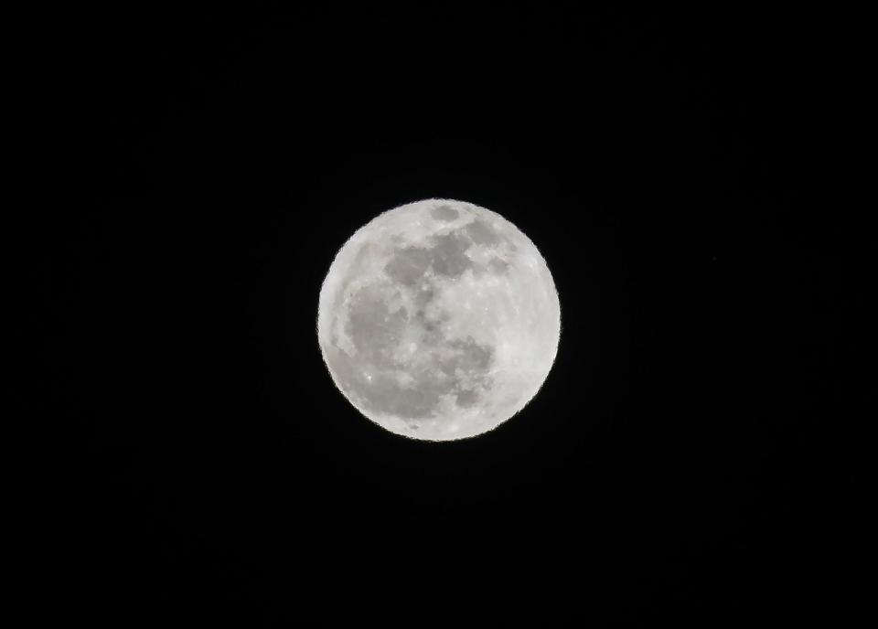 The full moon known as the pink moon illuminates the night sky in Palm Springs, Calif., April 23, 2024.