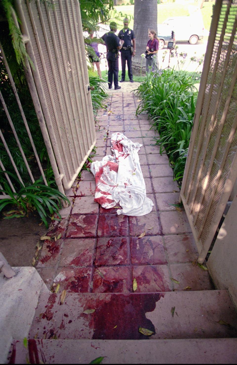 <p>Blood-stained sheets are strewn along the entryway of the west Los Angeles condominium of O.J. Simpson’s ex-wife, Nicole, on Monday, June 13, 1994, hours after she and a friend, Ronald Goldman, were found murdered there by a neighbor. (Photo: Eric Draper/AP) </p>