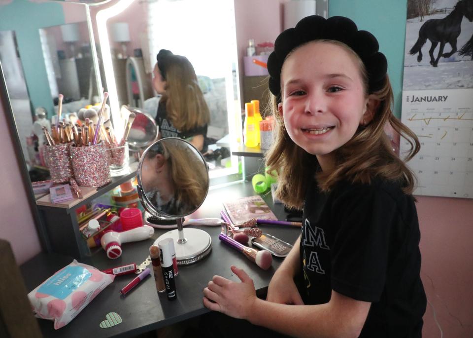 Jenna Teachman, 10, plays at her makeup table in her room recently.  Jenna took a fall off of a horse that led to the discovery of Stage 4 pancreatic cancer.