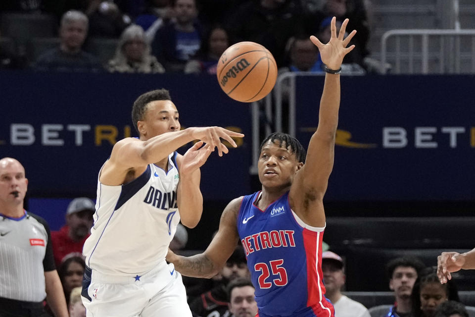 Dallas Mavericks guard Dante Exum (0) passes the ball as Detroit Pistons guard Marcus Sasser (25) defends during the first half of an NBA basketball game, Saturday, March 9, 2024, in Detroit. (AP Photo/Carlos Osorio)
