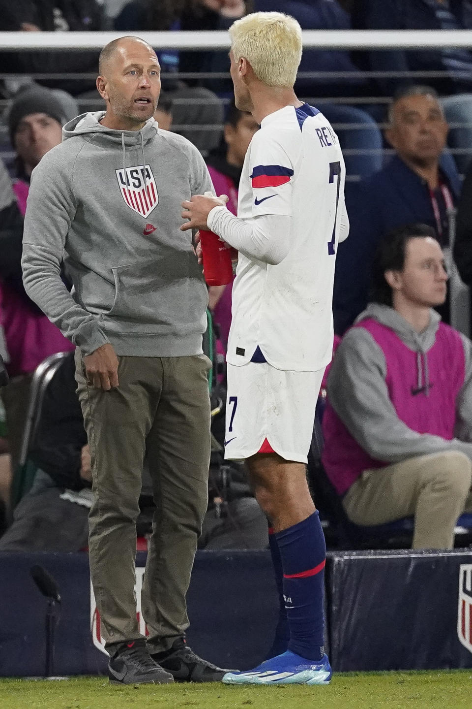 United States head coach Gregg Berhalter talks with midfielder Gio Reyna, right, during the first half of an international friendly soccer match against Ghana, Tuesday, Oct. 17, 2023, in Nashville, Tenn. (AP Photo/George Walker IV)