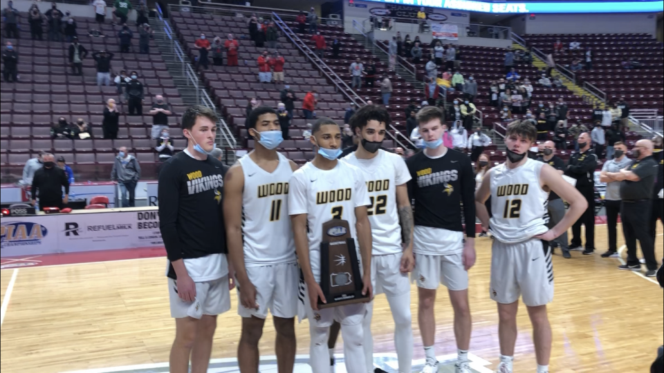Archbishop Wood poses with the PIAA Class 6A boys basketball runner-up trophy at the Giant Center.
