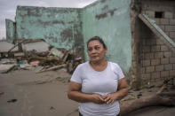 Guadalupe Cobos stands in her coastal community damaged by flooding driven by a Gulf of Mexico sea-level rise, in El Bosque, in the state of Tabasco, Mexico, Wednesday, Nov. 29, 2023. (AP Photo/Felix Marquez)