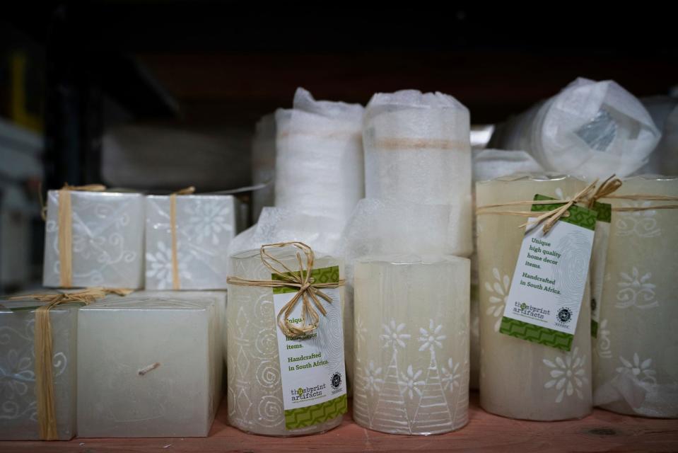 White on white hand poured and hand painted candles made by artisans in South Africa sit at a warehouse where orders from Thumbprint Artifacts are processed, packed and shipped in Detroit on Wednesday, Nov. 2, 2022.