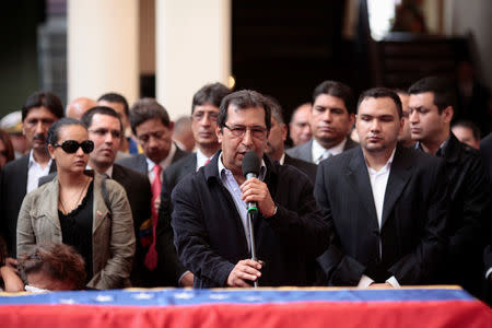 FILE PHOTO: Adan Chavez (C), brother of the Venezuela's late President Hugo Chavez, speaks next to his coffin during the funeral ceremony in Caracas March 15, 2013. Miraflores Palace/Handout via REUTERS/File Photo