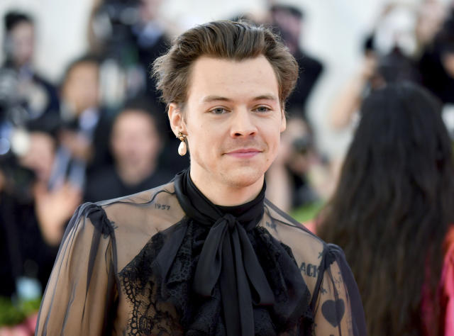 Harry Styles cuts a causal figure in a brown co-ord as he steps