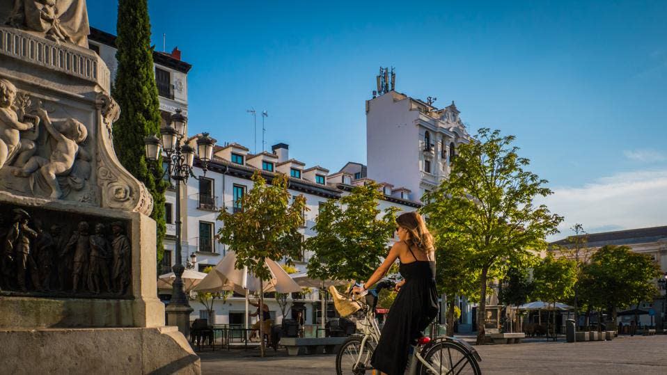 Una mujer joven en bicicleta en el Barrio de La Letras en el centro de Madrid, España