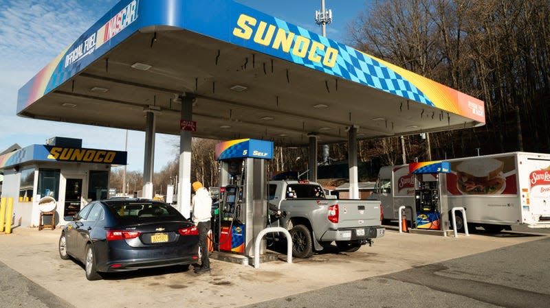 A customer refuels at a Sunoco gas station along Interstate 87 in Hastings-On-Hudson, New York, US, on Friday, Dec. 22, 2023.