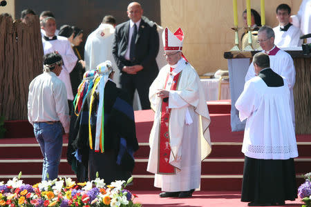 Pope Francis greets indegineous Mapuche people as he leads a mass at the Maquehue Temuco Air Force Base in Temuco, Chile, January 17, 2018. REUTERS/Edgard Garrido