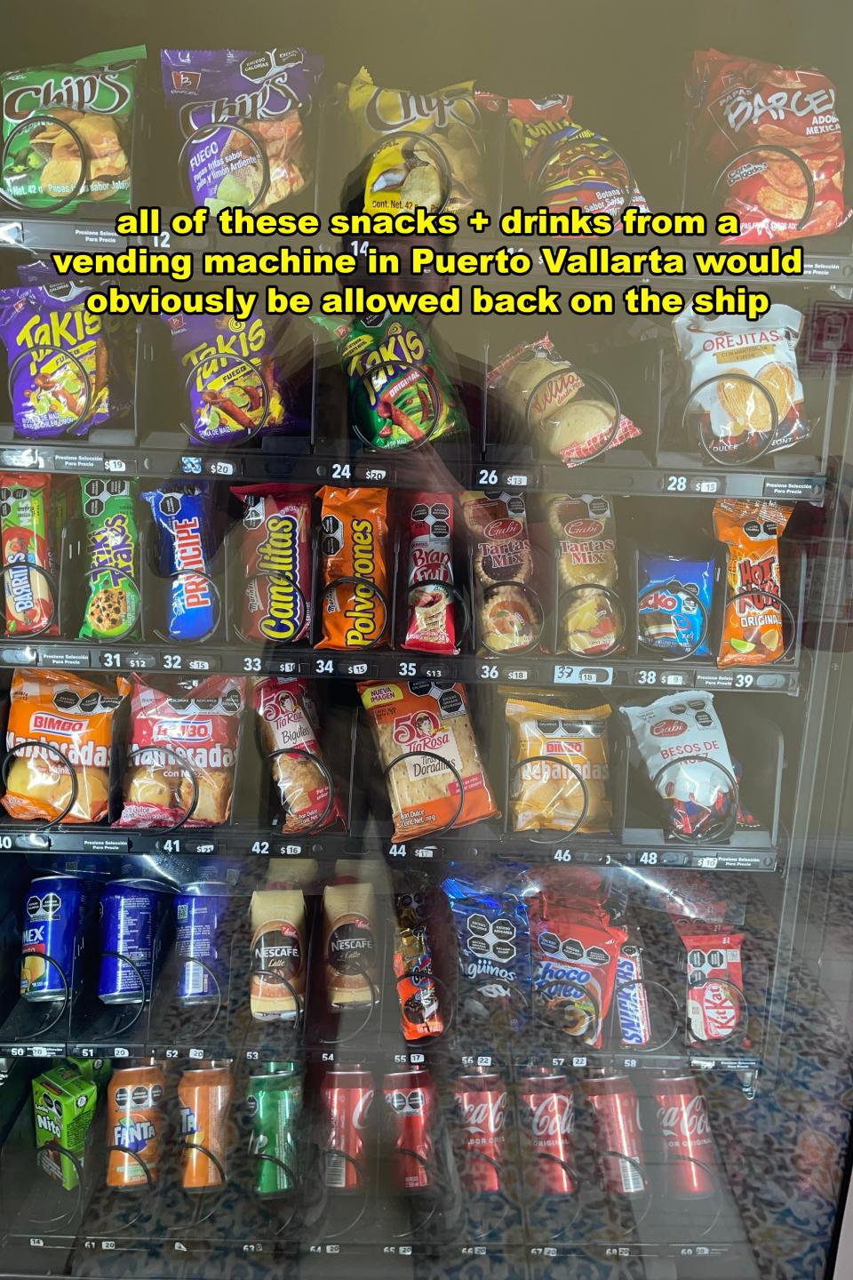 Vending machine filled with various snacks and drinks with a handwritten sign about Puerto Vallarta