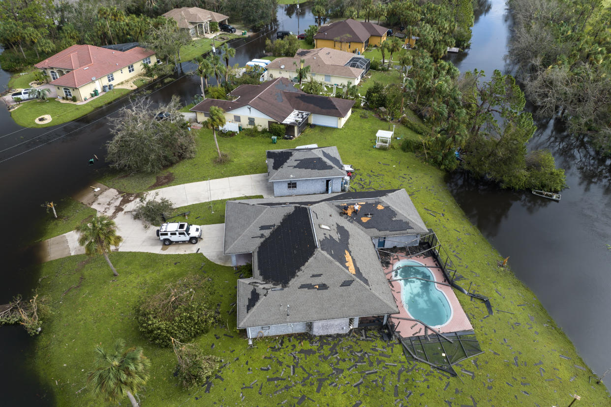 Destroyed house roof by hurricane Ian strong winds in Florida residential area. Natural disaster and its consequences.