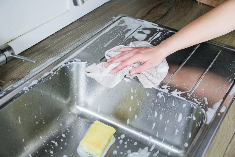 Cleaning the sink (Kinga Krzeminska / Getty Images)