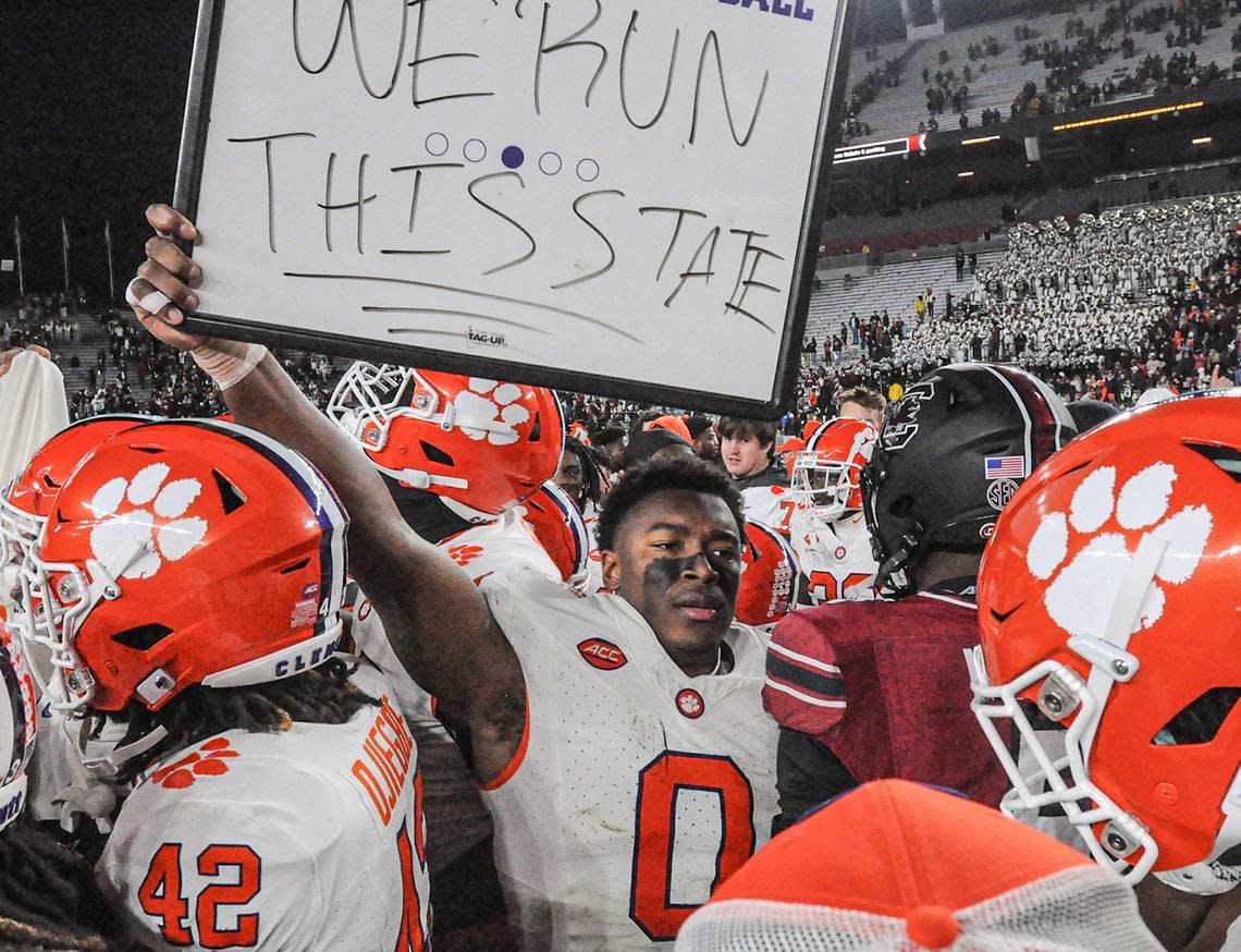 Clemson linebacker Barrett Carter (0) held a sign “We Run This State” after the Tigers beat South Carolina 16-7 in the 2023 regular-season finale.