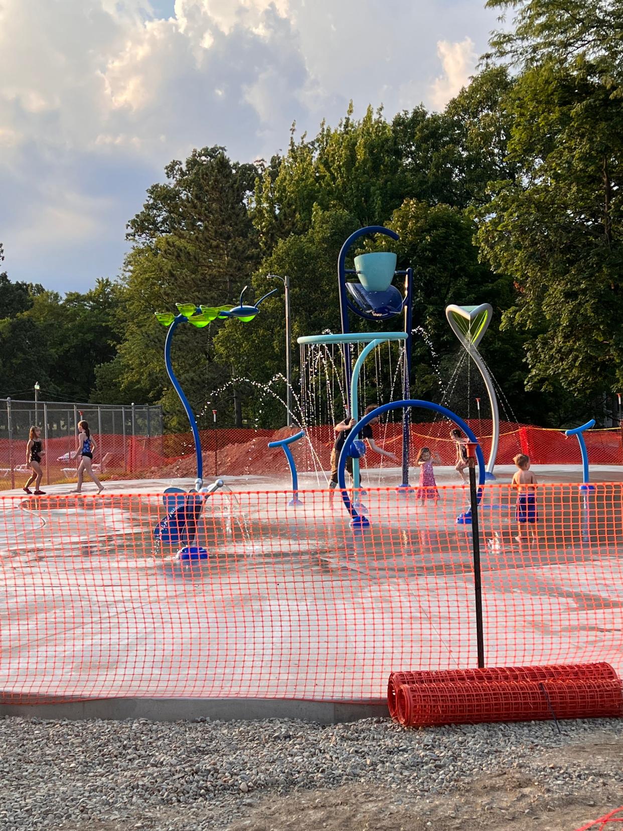 Children play in the spray ground area in Orrville, which opened July 1.