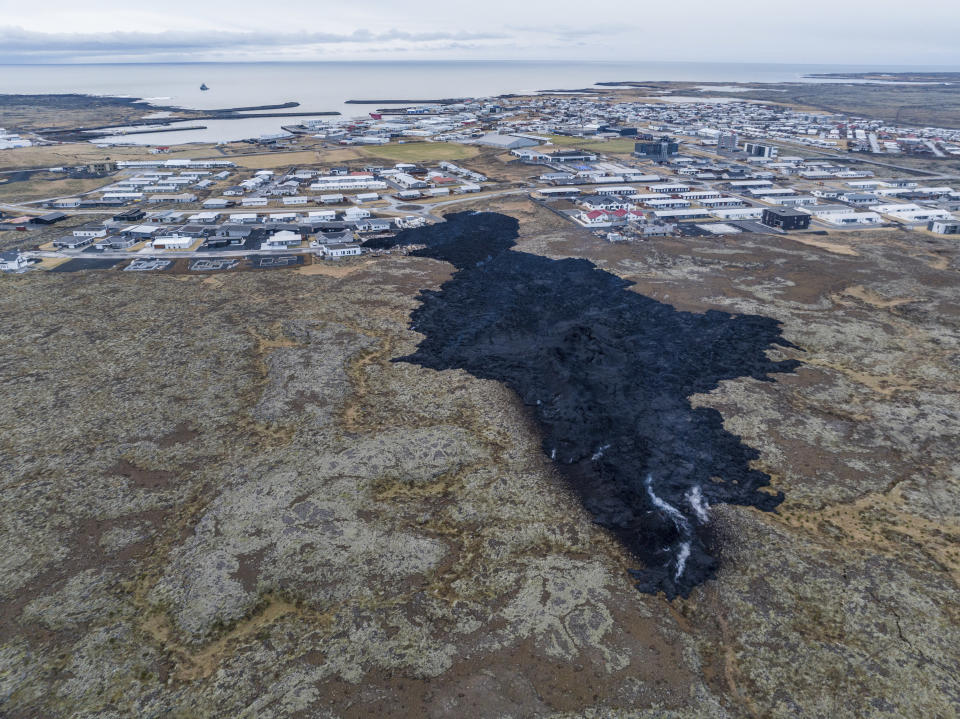 An areal view of the lava field with inactive southern fissure next to the town of Grindavik, Iceland, Monday, Jan. 15, 2024. Iceland's president says the country is battling "tremendous forces of nature" after molten lava from a volcano consumed several houses in the evacuated town of Grindavik. (AP Photo/ Marco Di Marco)