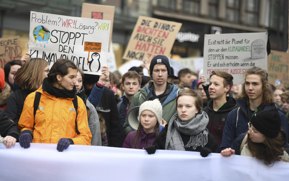 FILE -- In this Friday, March 1, 2019 photo Swedish climate activist Greta Thunberg, front with white cap, attends a protest rally in Hamburg, Germany. German Chancellor Angela Merkel is making clear she supports students protesting around the world against global warming, following widespread criticism of comments seeming to suggest the demonstrations may have been fomented by Russian online agitation. (Daniel Reinhardt/dpa via AP, file)