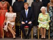 FILE PHOTO: Britain's Queen Elizabeth, Prince Harry and Meghan, the Duchess of Sussex pose for a picture with some of Queen's Young Leaders at a Buckingham Palace reception following the final Queen's Young Leaders Awards Ceremony, in London