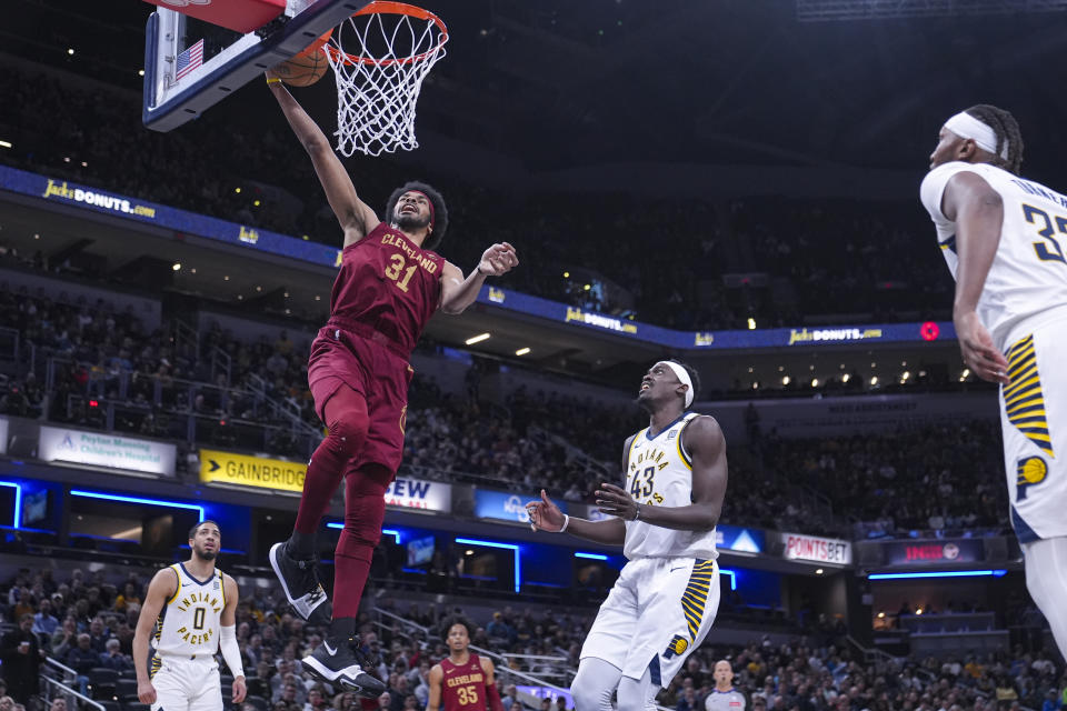 Cleveland Cavaliers center Jarrett Allen (31) gets a basket over Indiana Pacers forward Pascal Siakam (43) during the first half of an NBA basketball game in Indianapolis, Monday, March 18, 2024. (AP Photo/Michael Conroy)