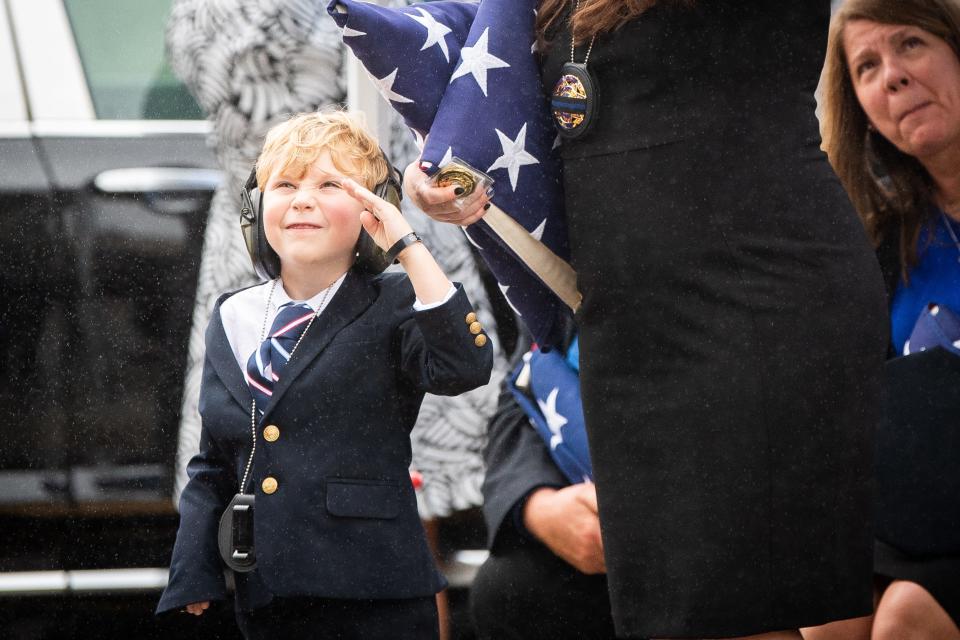 Hendrik Blakely, son of Tucker Blakely, gives a salute to the helicopters flying over Clear Springs Baptist Church in Corryton.