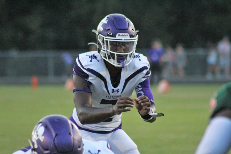 Super 11 quarterback Marcelis Tate awaits the snap during first half action of Fletcher's season opener against Mandarin.