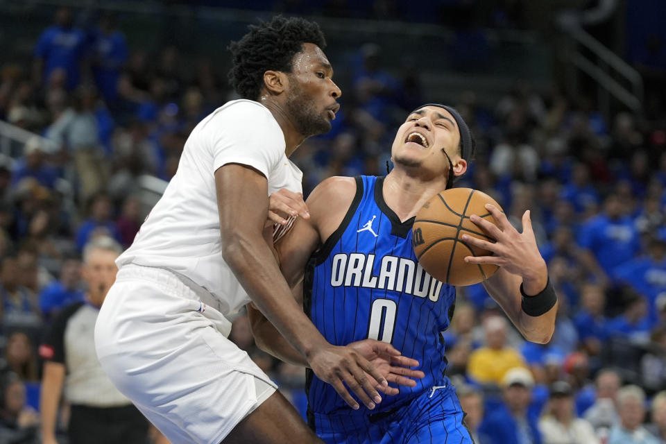 Orlando Magic guard Anthony Black (0) collides with Cleveland Cavaliers center Damian Jones during the second half of Game 3 of an NBA basketball first-round playoff series Thursday, April 25, 2024, in Orlando, Fla. (AP Photo/John Raoux)