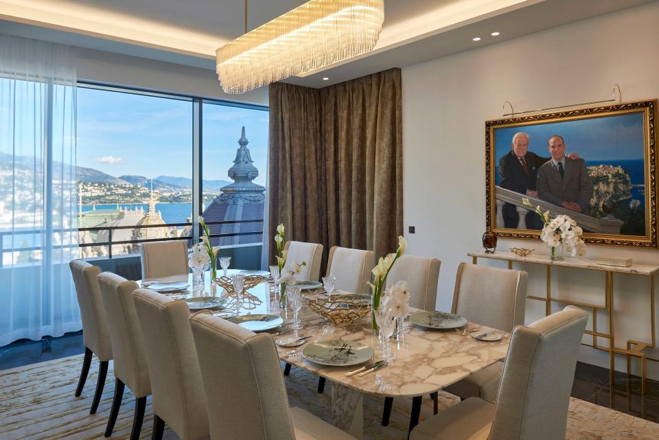 A vibrant painting of father and son, selected by Prince Albert II and loaned by the palace, presides over the dining room in the Prince Rainier III Suite.