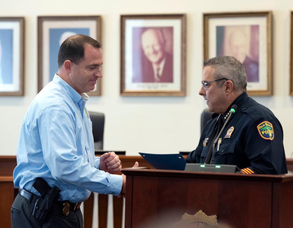 Palm Beach Police Detective Adam Zeller is awarded Officer of the Month for April 2023 by Police Chief Nicholas Caristo on Friday.