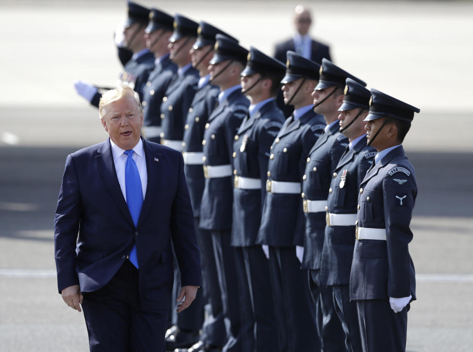 President Donald Trump is greeted by an honor guard as he and first lady Melania Trump arrive at Stansted Airport in England, Monday, June 3, 2019 at the start of a three day state visit to Britain. (AP Photo/Kirsty Wigglesworth)