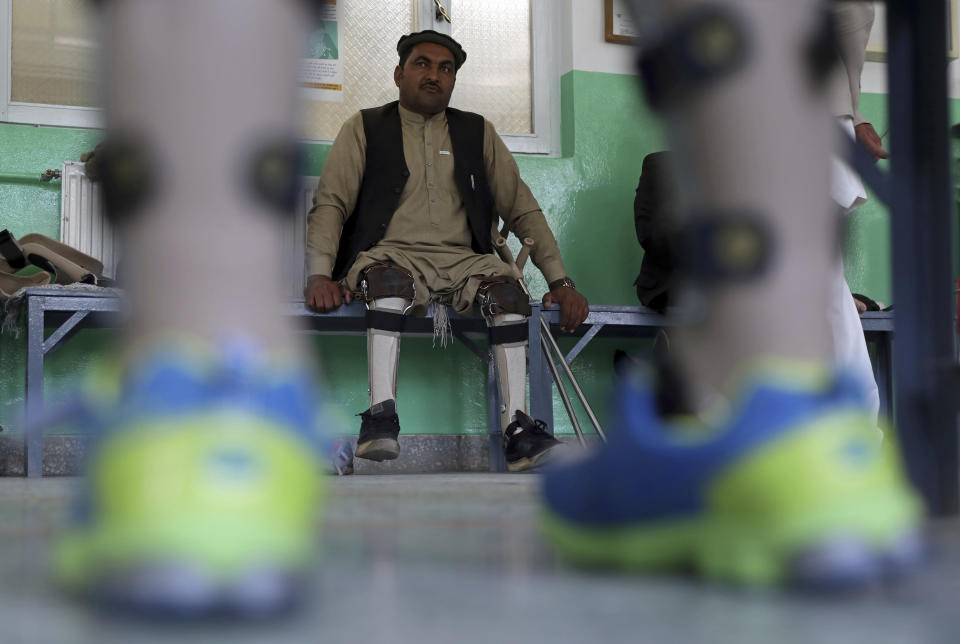 Afghan polio patient Maiwa Gul waits to have his orthopedic devices checked at the International Committee of the Red Cross’ Orthopedic Program, in Kabul, Afghanistan, Monday, March 29, 2021. In 2020, nearly 5,000 polio patients received treatment at the program, including physiotherapy, medical equipment and orthopedic devices. (AP Photo/Rahmat Gul)