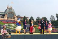 Joe Schott, front right, president and general manager of Shanghai Disney Resort, speaks during its reopening ceremony after the coronavirus closure in Shanghai, China, Monday, May 11, 2020. Visits will be limited initially and must be booked in advance, and the company said it will increase cleaning and require social distancing in lines for the various attractions(AP Photo/Si Chen)