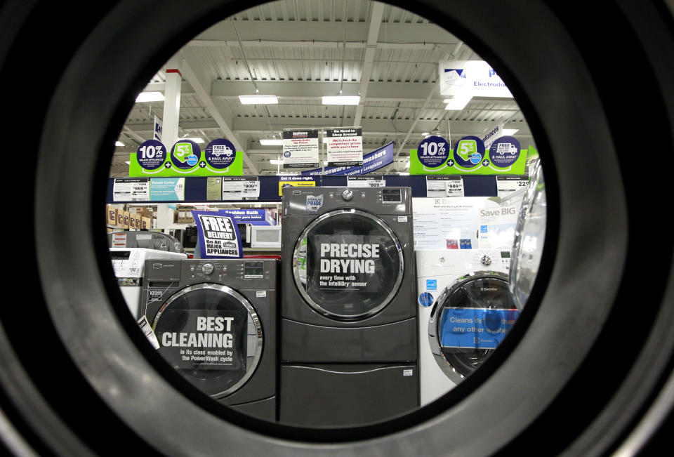 In this Monday, Sept. 10, 2012 photo, dryers are seen from the inside of another clothes' dryer, foreground, at a Lowe's store location, in Framingham, Mass. U.S. companies remained cautious in September and held back on orders for long-lasting manufactured goods that signal investment plans. (AP Photo/Steven Senne)