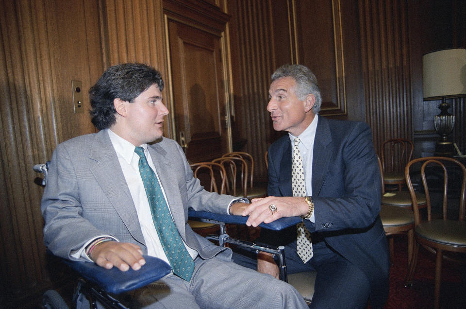 FILE - In this June 28, 1989, file photo, Marc Buoniconti, left, and his father, former Miami Dolphins player Nick Buoniconti, speak after Marc received the American Institute for Public Service Jefferson Award at the Supreme Court in Washington. Pro Football Hall of Fame middle linebacker Nick Buoniconti, an undersized overachiever who helped lead the Miami Dolphins to the NFL's only perfect season, has died at the age of 78. Bruce Bobbins, a spokesman for the Buoniconti family, said he died Tuesday, July 30, 2019, in Bridgehampton, N.Y. (AP Photo/J. Scott Applewhite)