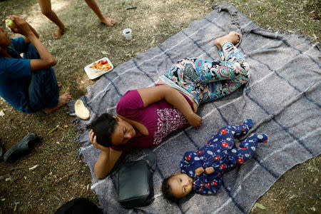 Aide and her baby son Clesner from Guatemala, rest along with fellow Central American migrants, who are moving in a caravan through Mexico toward the U.S. border, at a shelter set up for them by the Catholic church, in Puebla, Mexico April 6, 2018. REUTERS/Edgard Garrido