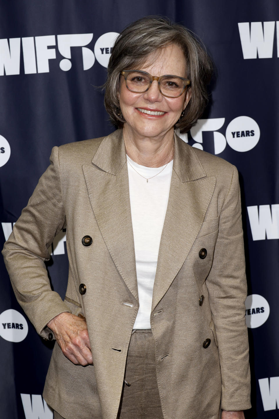 closeup of her in a blazer and short hair