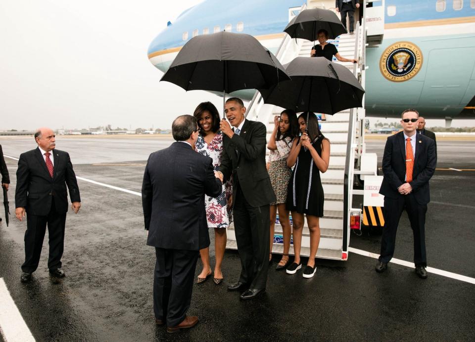 Obama, first lady Michelle Obama, and daughters Malia and Sasha greet dignitaries upon arriving in Havana.