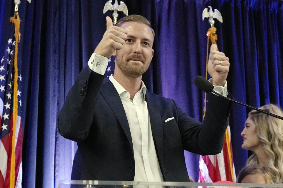 FILE - Ryan Walters, Republican candidate for state superintendent of public instruction, gestures to the crowd during a Republican watch party Nov. 8, 2022, in Oklahoma City. When Oklahoma's newly elected Republican head of public schools campaigned for the job last fall, he ran on a platform of fighting "woke ideology" in public schools, banning certain books from school libraries, empowering parents with school choice and getting rid of "radical leftists" he claims were indoctrinating children in classrooms across the state. (AP Photo/Sue Ogrocki, File)