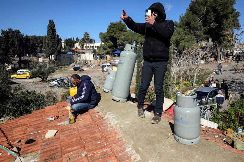 Palestinians take to the roof and threaten to blow-up the building of a home in the flashpoint Sheikh Jarrah neighbourhood of East Jerusalem