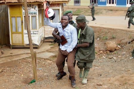 Congolese soldiers arrest a civilian protesting against the government's failure to stop the killings and inter-ethnic tensions in the town of Butembo, North Kivu province in the Democratic Republic of Congo, August 24, 2016. REUTERS/Kenny Katombe