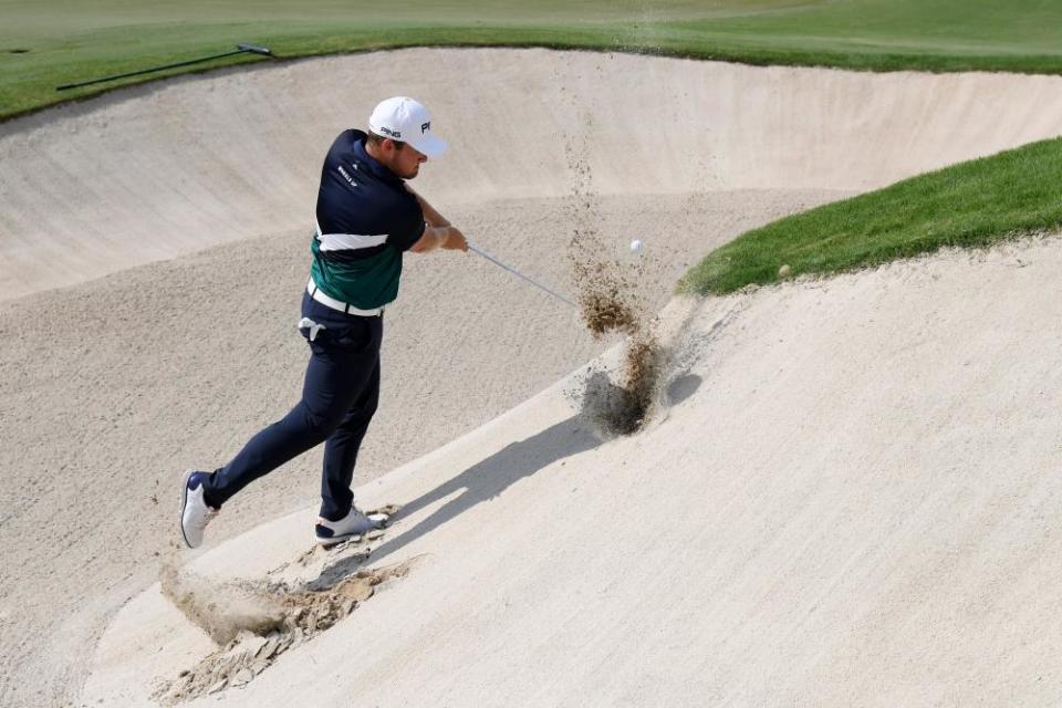 Tyrrell Hatton attempts to battle his way of the sand on 18.