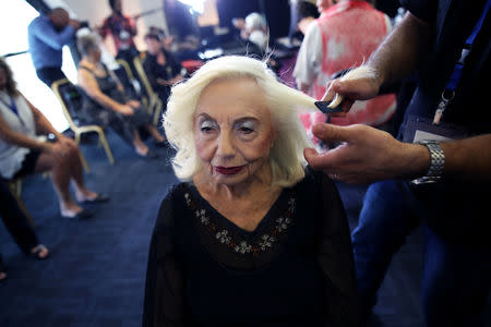 Holocaust survivor Rita Kasimow Brown, 85, gets her hair done before the beginning of the annual Holocaust survivors' beauty pageant in Haifa, Israel October 14, 2018. REUTERS/Corinna Kern