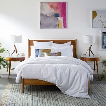 <p><strong>West Elm</strong></p><p>westelm.com</p><p><strong>$1399.00</strong></p><p>Featuring mid-century modern elements, this wooden bed frame from West Elm <strong>combines vintage style with modern design for a streamlined look</strong>. We love that the bed frame uses sustainably harvested wood and is produced in a Fair Trade Certified facility. You can choose a traditional wood, white or gray finish, and the bed has eight inches of clearance underneath, leaving plenty of room for storage. The brand also offers tons of <a href="https://go.redirectingat.com?id=74968X1596630&url=https%3A%2F%2Fwww.westelm.com%2Fsearch%2Fresults.html%3Fwords%3DMid-Century&sref=https%3A%2F%2Fwww.goodhousekeeping.com%2Fhome-products%2Fg35254069%2Fbest-bed-frames%2F" rel="nofollow noopener" target="_blank" data-ylk="slk:matching furniture, including nightstands and dressers;elm:context_link;itc:0;sec:content-canvas" class="link ">matching furniture, including nightstands and dressers</a>. There is, however, a $159 white-glove delivery fee. <br></p>